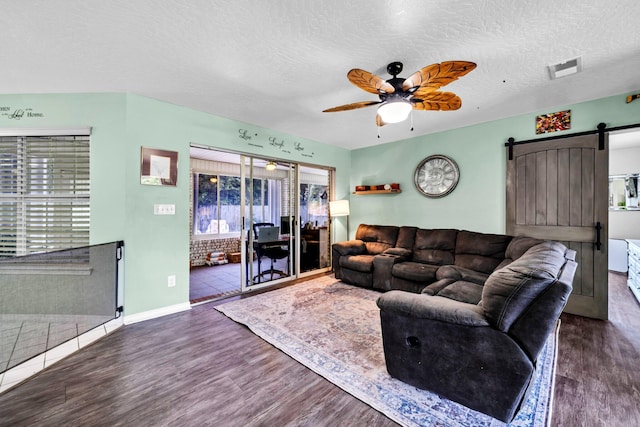 2542 Edgewood Dr, Navarre, FL 32566 - living room with ceiling fan, plenty of natural light, a barn door, wood finished floors, and a textured ceiling