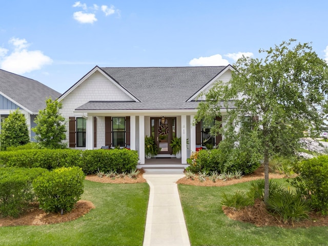 10 Basal St, Inlet Beach, FL 32461 - view of front of property featuring a shingled roof, a porch, and a front lawn