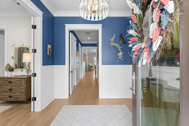10 Basal St, Inlet Beach, FL 32461 - hall with wood finished floors, a wainscoted wall, a chandelier, and ornamental molding