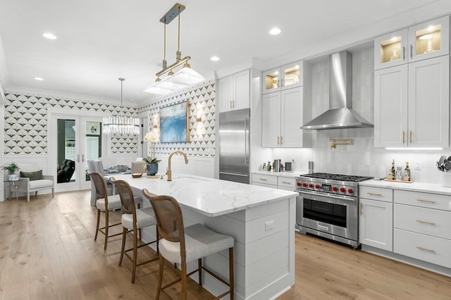 10 Basal St, Inlet Beach, FL 32461 - kitchen featuring high quality appliances, wall chimney exhaust hood, wallpapered walls, a sink, and light wood-type flooring