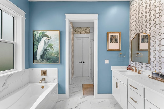 10 Basal St, Inlet Beach, FL 32461 - bathroom with marble look tile flooring, baseboards, a garden tub, and vanity