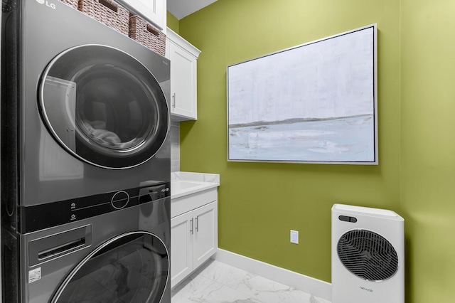 10 Basal St, Inlet Beach, FL 32461 - laundry room featuring stacked washer / drying machine, cabinet space, baseboards, and light marble finish floors