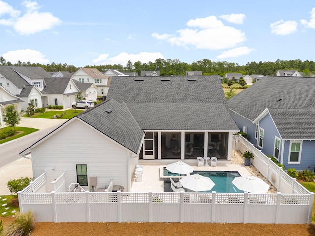 10 Basal St, Inlet Beach, FL 32461 - rear view of house featuring a sunroom, a shingled roof, a fenced backyard, a patio, and a residential view