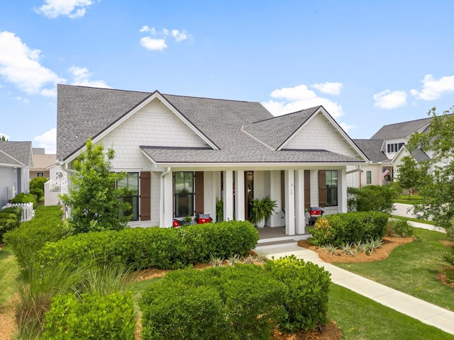 10 Basal St, Inlet Beach, FL 32461 - view of front of house with a porch, a shingled roof, and a front yard