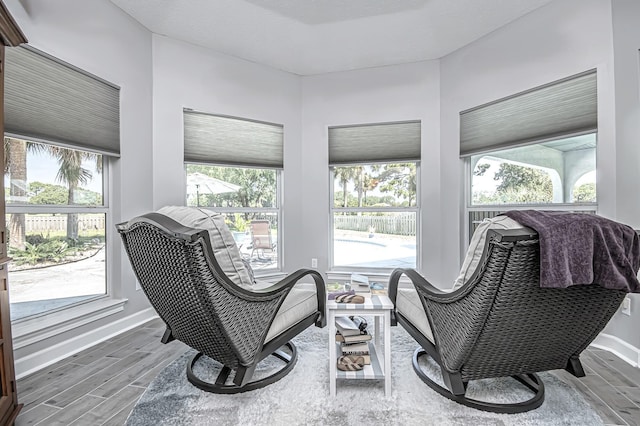 living area featuring wood finished floors and baseboards