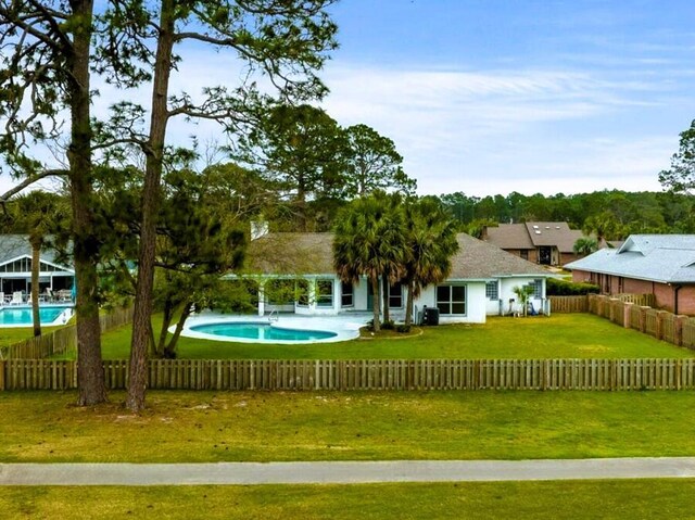 exterior space featuring a fenced in pool, a yard, and fence private yard