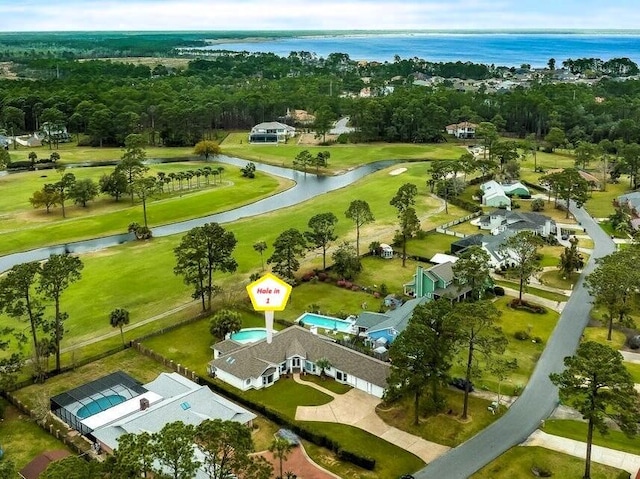 birds eye view of property featuring golf course view and a water view