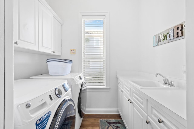 48 Tranquility Ln, Destin, FL 32541 - washroom with washing machine and clothes dryer, a sink, dark wood-style floors, baseboards, and cabinet space