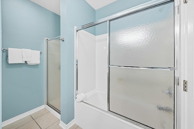 bathroom featuring tile patterned floors, a bathing tub, an enclosed shower, and baseboards