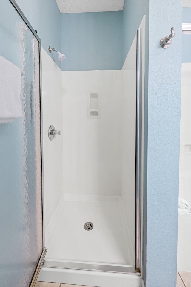 bathroom featuring a stall shower and tile patterned flooring