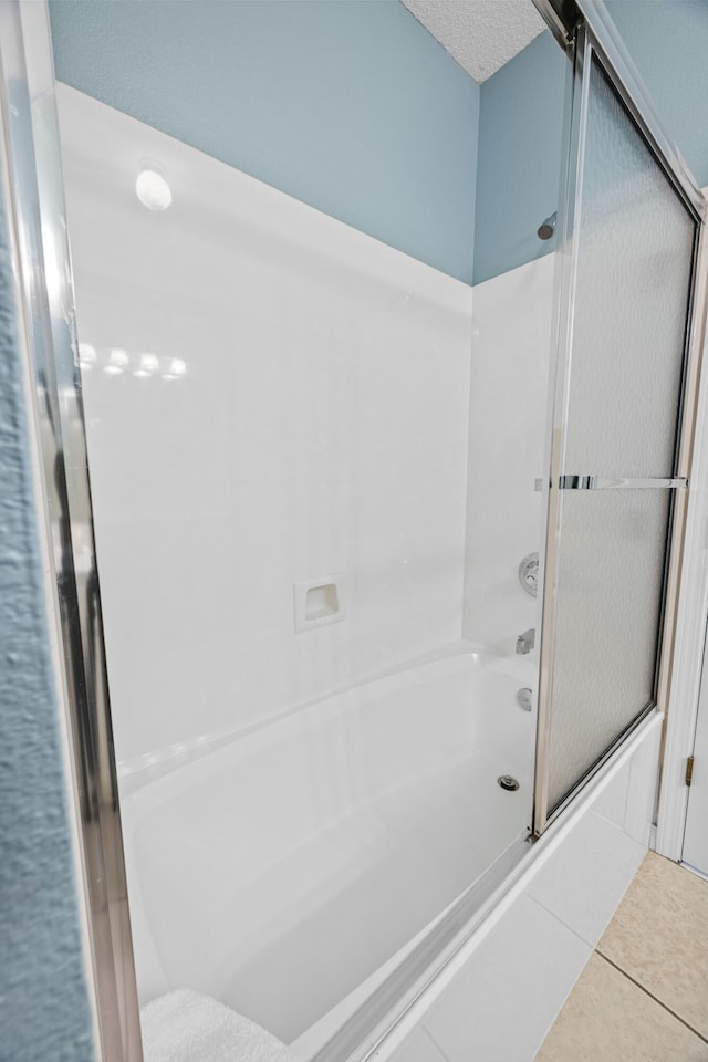 bathroom with enclosed tub / shower combo and tile patterned floors