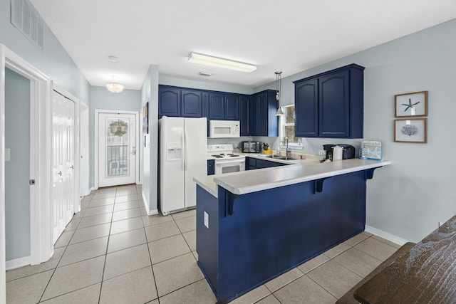 kitchen featuring blue cabinetry, white appliances, visible vents, and a sink