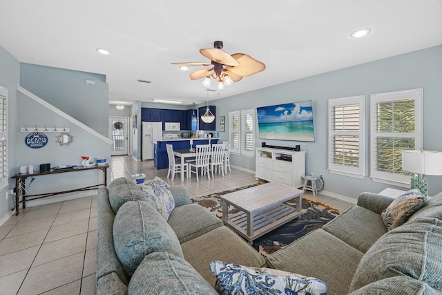 living area featuring light tile patterned floors, ceiling fan, recessed lighting, and baseboards