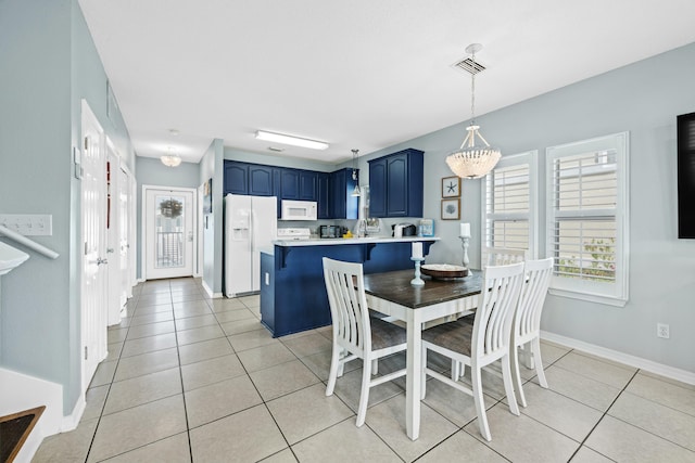 dining space with light tile patterned flooring, visible vents, and baseboards