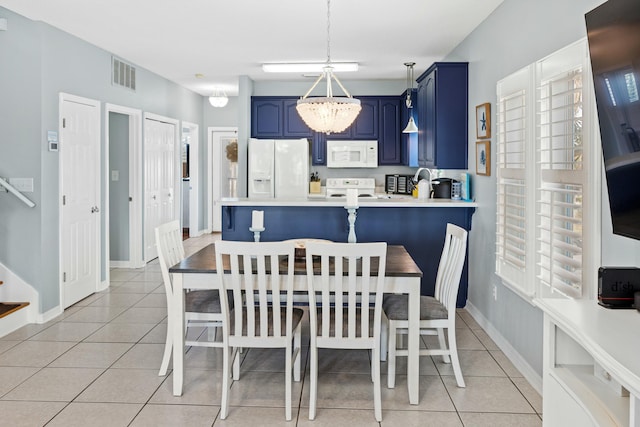 dining area featuring light tile patterned floors, a notable chandelier, visible vents, and baseboards