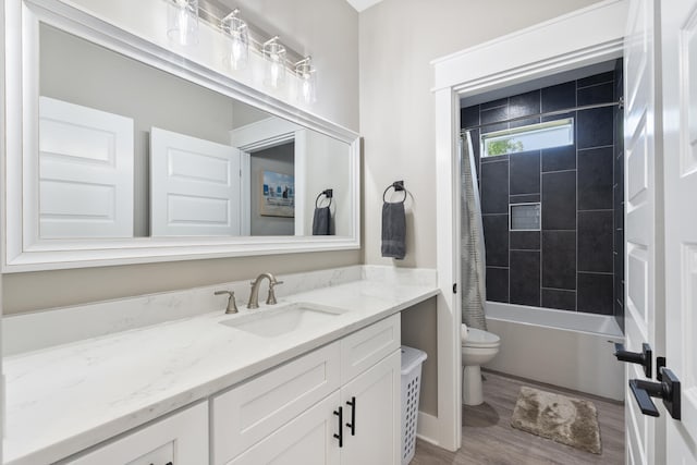 full bathroom with vanity, wood finished floors, shower / bath combo, and toilet