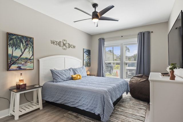 bedroom with baseboards, a ceiling fan, and wood finished floors