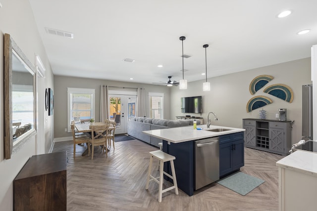 kitchen featuring recessed lighting, ceiling fan, stainless steel dishwasher, and blue cabinets