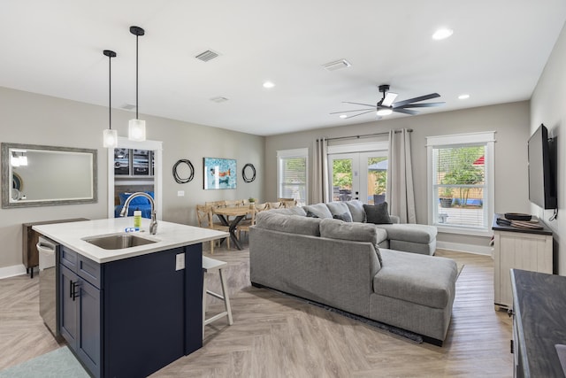 living area with a healthy amount of sunlight, a ceiling fan, recessed lighting, and visible vents