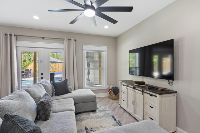 living area with baseboards, ceiling fan, recessed lighting, french doors, and light wood finished floors