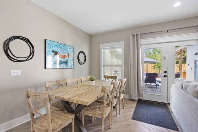 dining space featuring french doors, recessed lighting, light wood finished floors, and baseboards