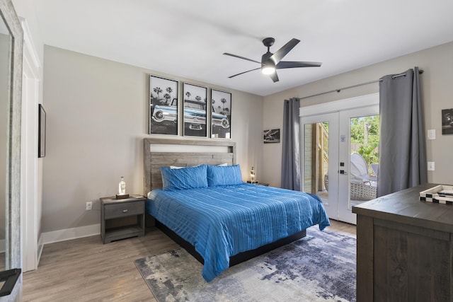 bedroom featuring a ceiling fan, access to exterior, french doors, and wood finished floors