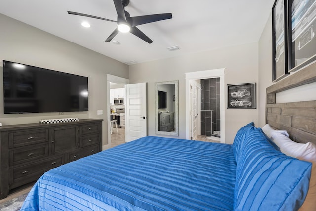 bedroom featuring ceiling fan, ensuite bath, and visible vents