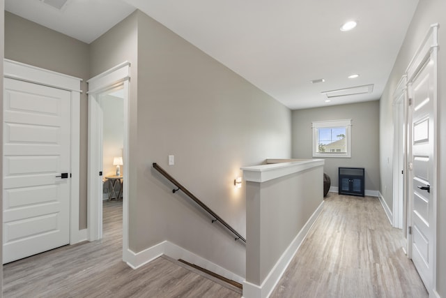 corridor featuring recessed lighting, baseboards, an upstairs landing, and light wood finished floors