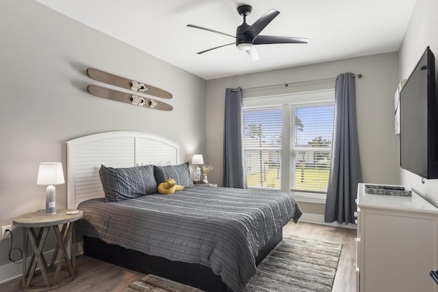 bedroom with a ceiling fan and light wood-style flooring