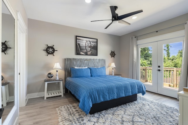 bedroom with baseboards, access to exterior, french doors, and wood finished floors