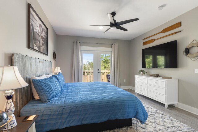 bedroom featuring access to outside, baseboards, a ceiling fan, and wood finished floors