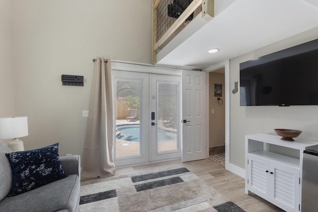 doorway to outside with light wood-style floors, baseboards, french doors, and recessed lighting