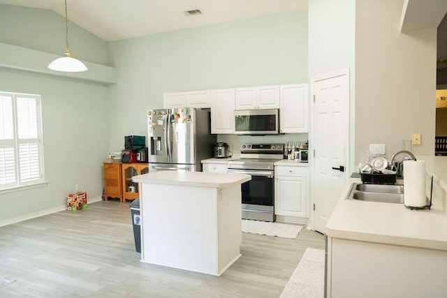 kitchen featuring high vaulted ceiling, stainless steel appliances, visible vents, and a sink