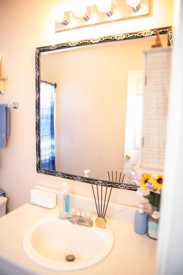 bathroom featuring vanity and toilet