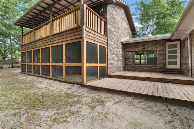 255 Brackin St, Crestview, FL 32539 - back of property featuring brick siding, a balcony, and a sunroom