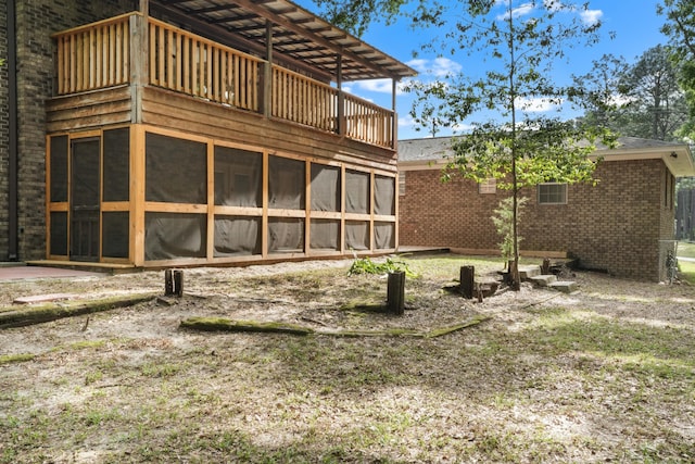 255 Brackin St, Crestview, FL 32539 - rear view of property with brick siding, a balcony, and a sunroom