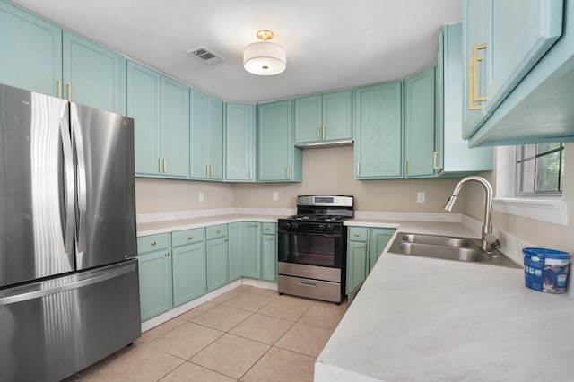 255 Brackin St, Crestview, FL 32539 - kitchen with a sink, light countertops, range with gas stovetop, freestanding refrigerator, and visible vents