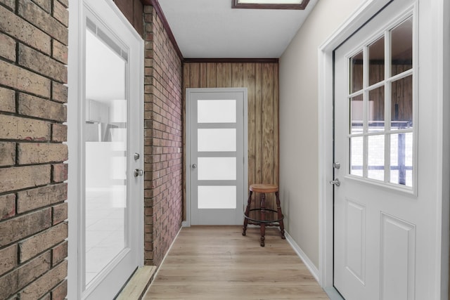 255 Brackin St, Crestview, FL 32539 - doorway to outside with light wood finished floors and brick wall