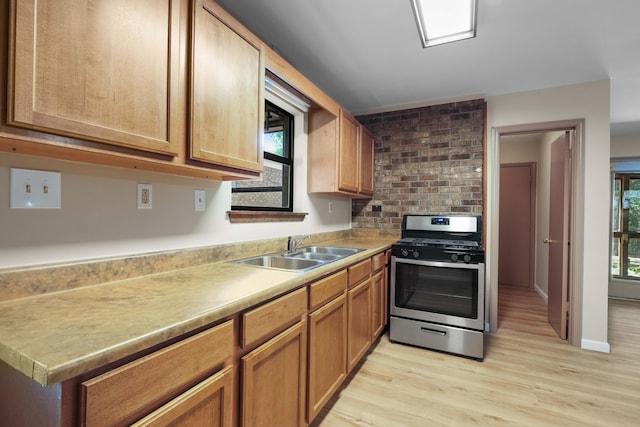 255 Brackin St, Crestview, FL 32539 - kitchen with a sink, stainless steel gas range oven, light wood-style floors, light countertops, and baseboards