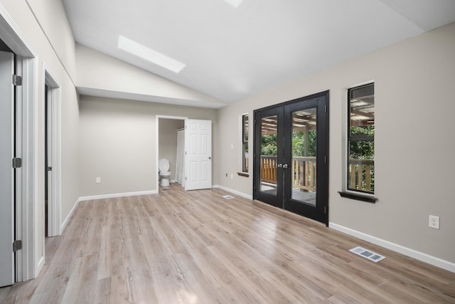 255 Brackin St, Crestview, FL 32539 - unfurnished room with vaulted ceiling with skylight, french doors, visible vents, baseboards, and light wood-style flooring