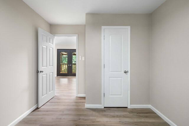 255 Brackin St, Crestview, FL 32539 - corridor with baseboards, french doors, and light wood-style flooring