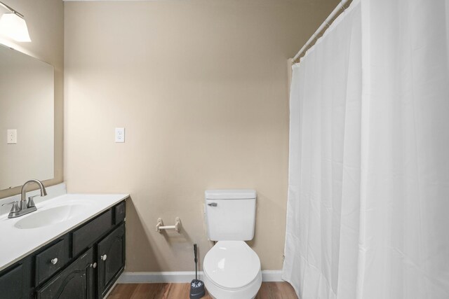 255 Brackin St, Crestview, FL 32539 - bathroom featuring vanity, baseboards, toilet, and wood finished floors