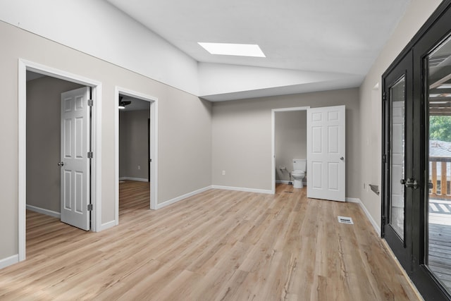 255 Brackin St, Crestview, FL 32539 - unfurnished bedroom featuring vaulted ceiling with skylight, access to exterior, visible vents, baseboards, and light wood finished floors