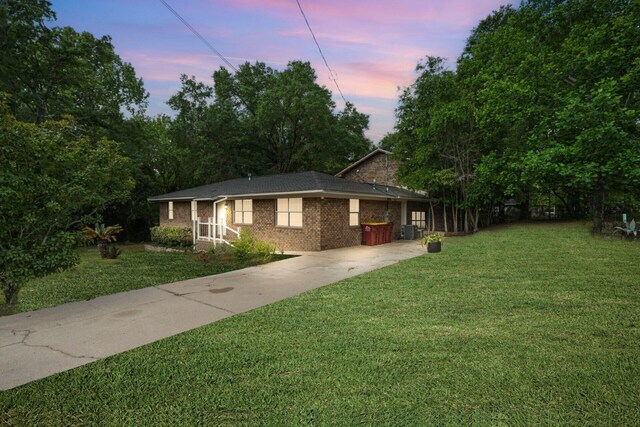 255 Brackin St, Crestview, FL 32539 - view of front of property featuring central air condition unit, driveway, brick siding, and a front yard