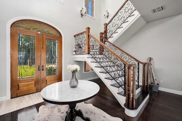 foyer with stairs, visible vents, and a healthy amount of sunlight