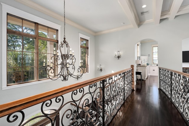 hallway featuring dark wood-style flooring, a notable chandelier, arched walkways, beamed ceiling, and visible vents