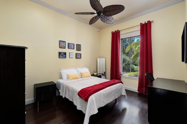 bedroom featuring crown molding, dark wood-style flooring, ceiling fan, and baseboards