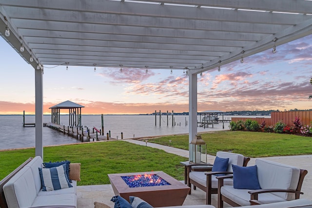 view of patio / terrace with a water view, an outdoor living space with a fire pit, a pergola, and a dock