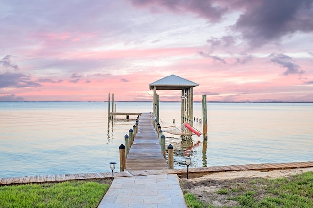 dock area featuring boat lift and a water view