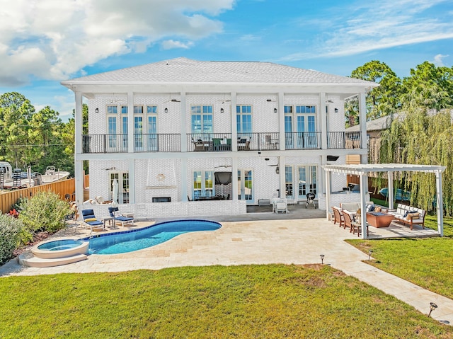 back of property featuring french doors, a lawn, an outdoor hangout area, a balcony, and a patio